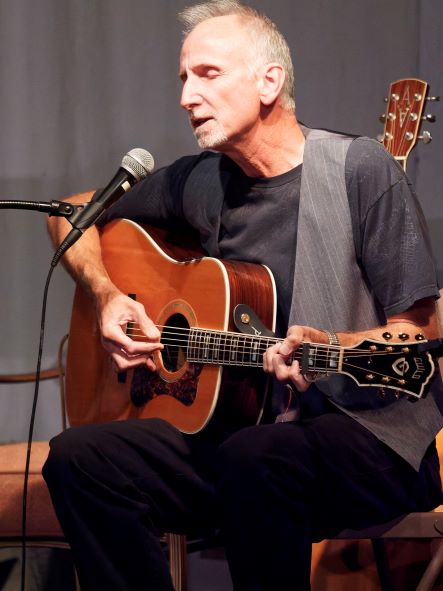 Dave Gallaghar singing and playing guitar