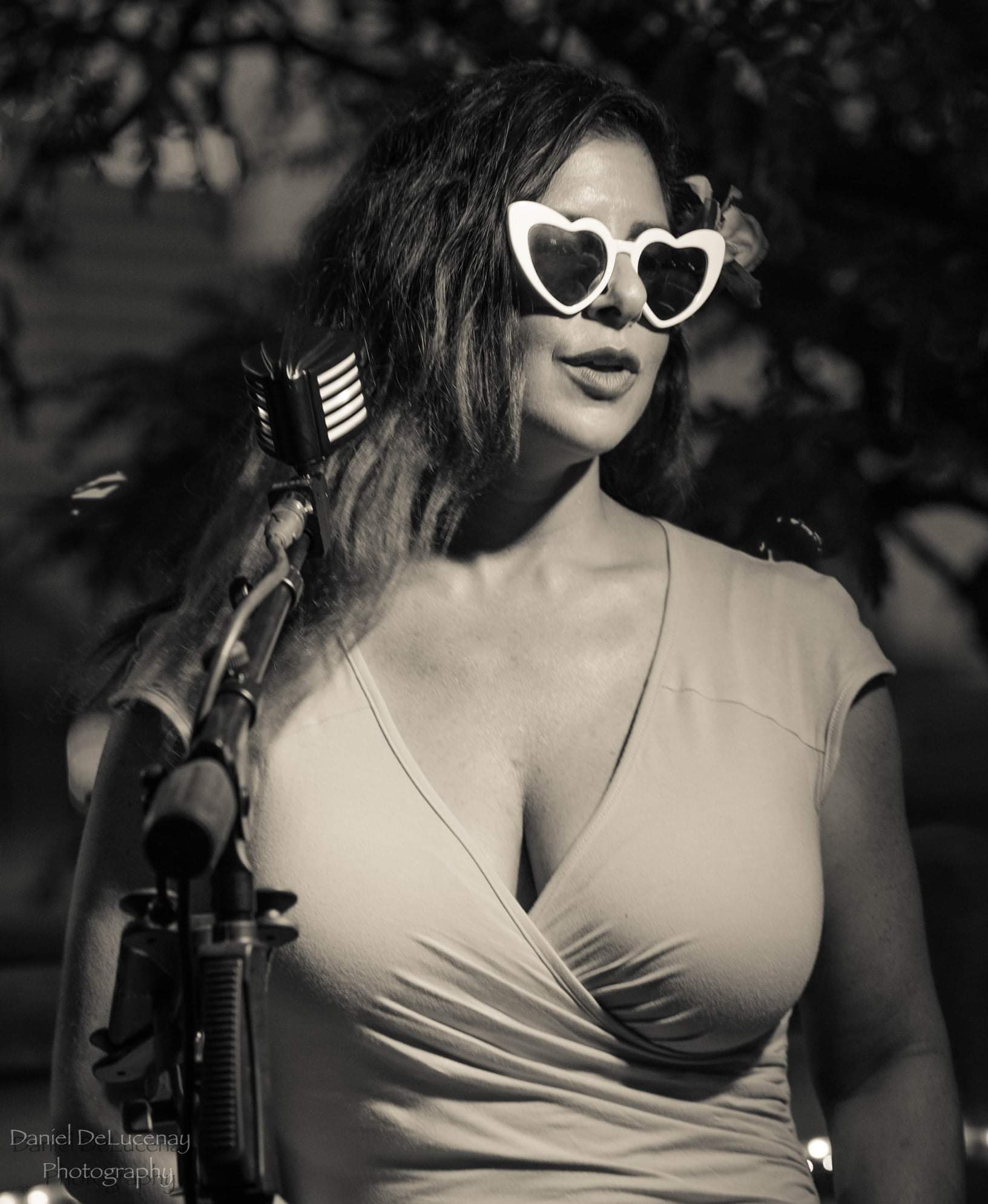 Portrait of Amanda Ashley wearing white heart shaped sunglasses