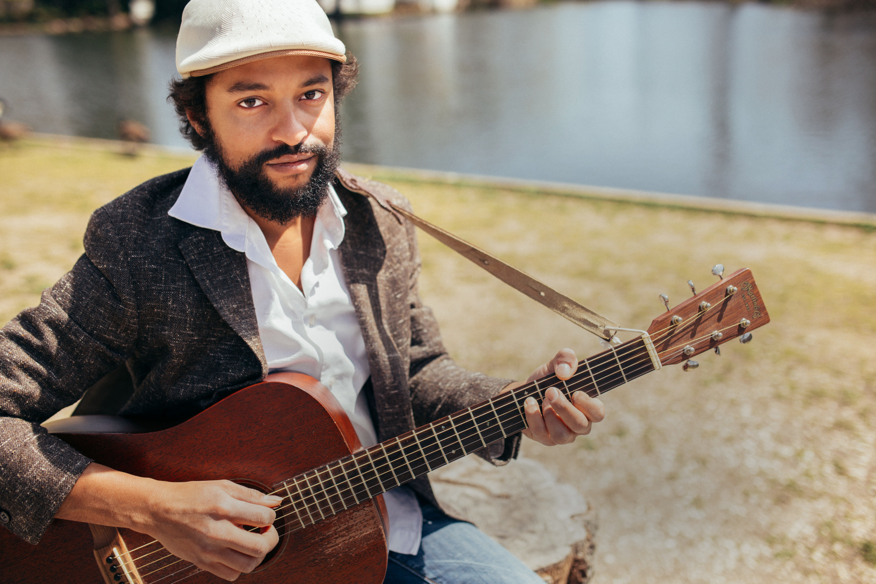 Portrait of Dallas Louis with his guitar.