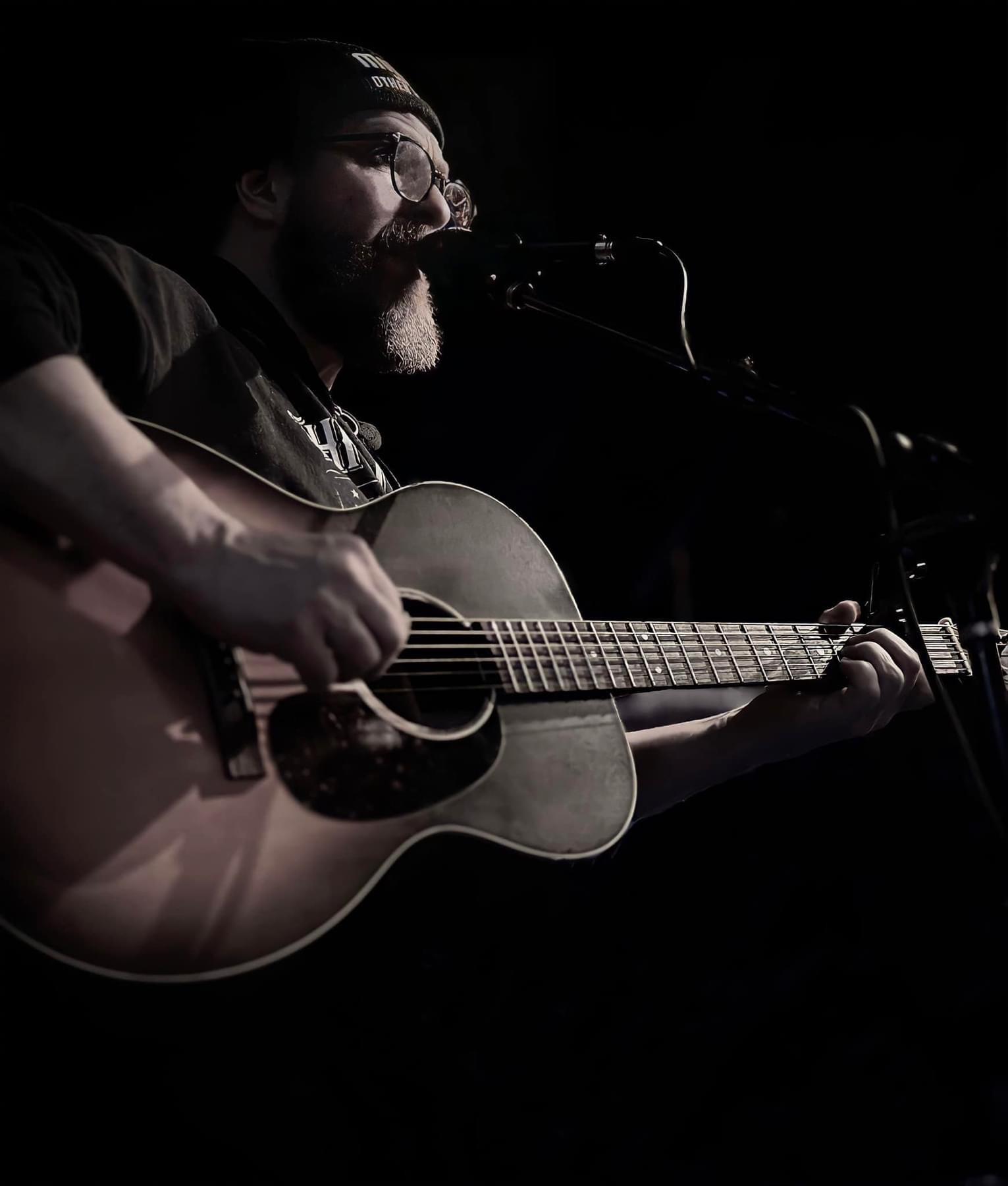 David Miller performing, singing, playing the guitar