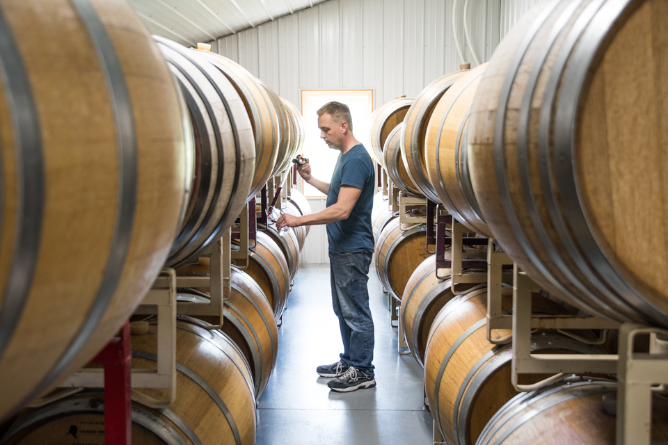 Craig with wine barrels.