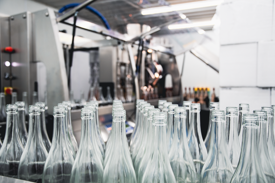 Image of bottles in front of bottling line.