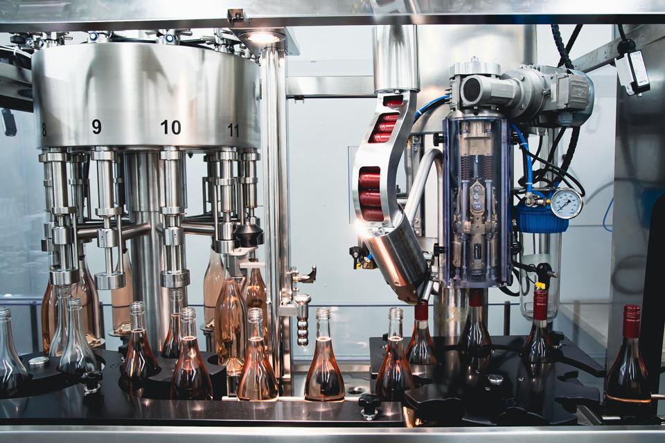 Image of bottles being filled on bottling line.