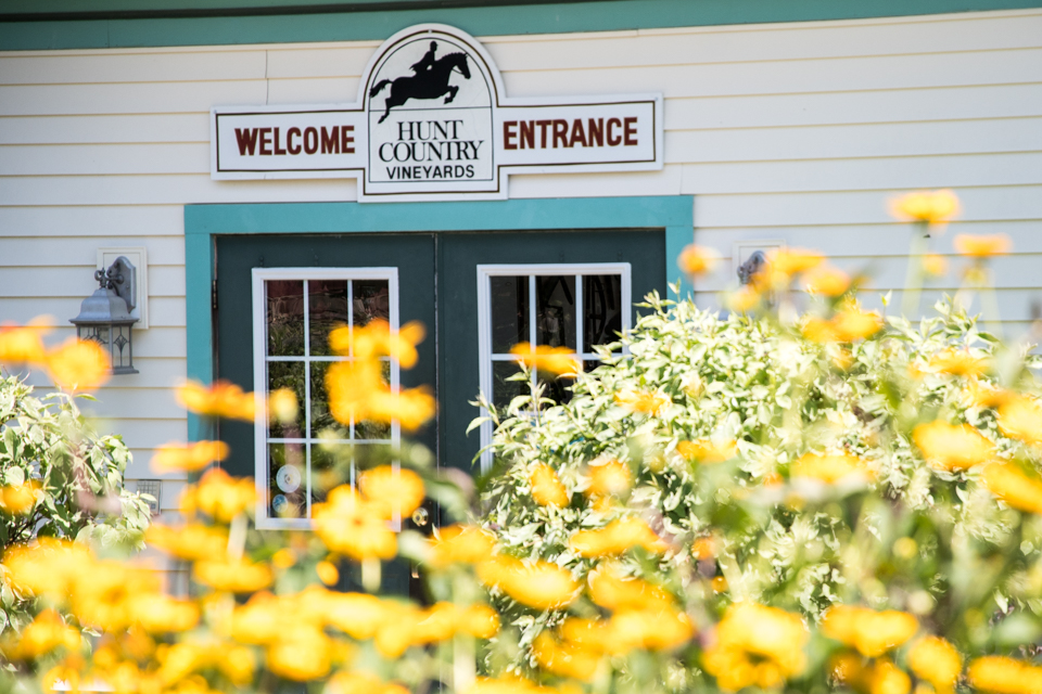 Image of front door behind flowers.