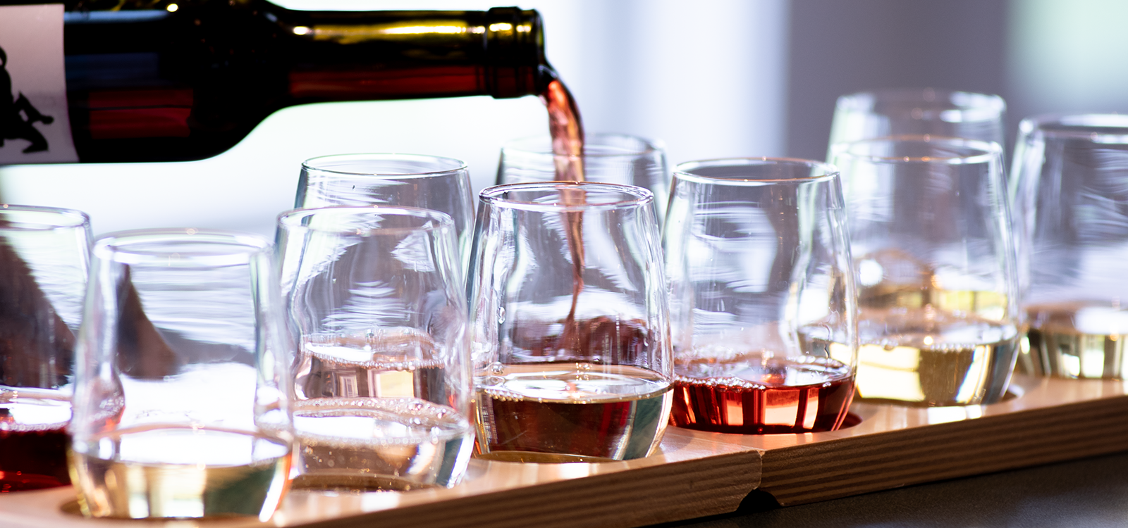 Image of pouring wine into glasses.