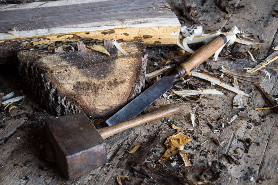 Image of hammer, chisel, split log.