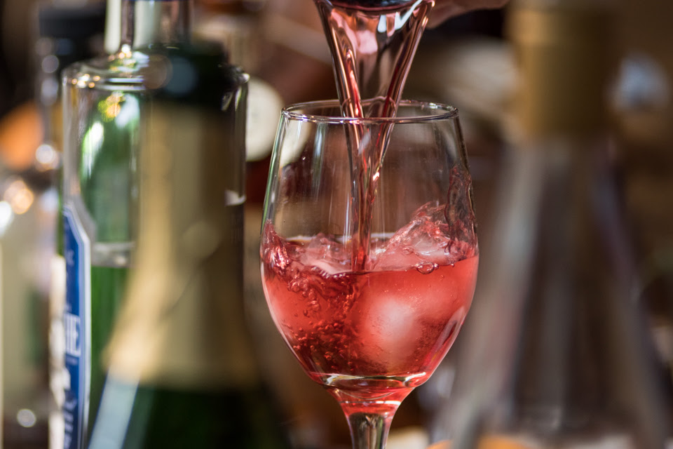 Image of sangria being poured into glass.