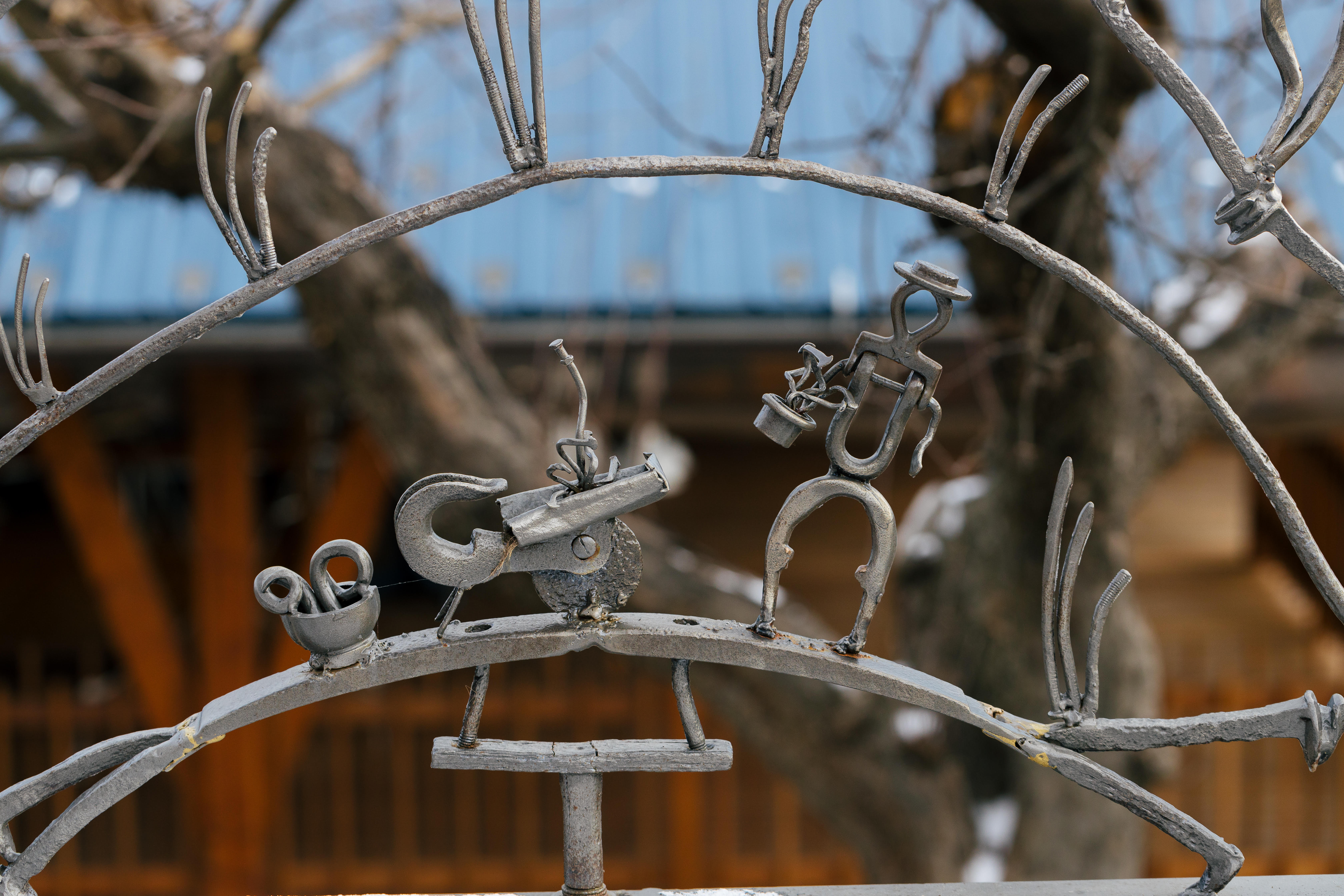 Tony Moretti Sculptural Detail: Includes person made from metal scraps